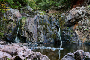 Two small strams are seen going over the rocks of Joe Howe Falls, in Victoria Park near Truro.